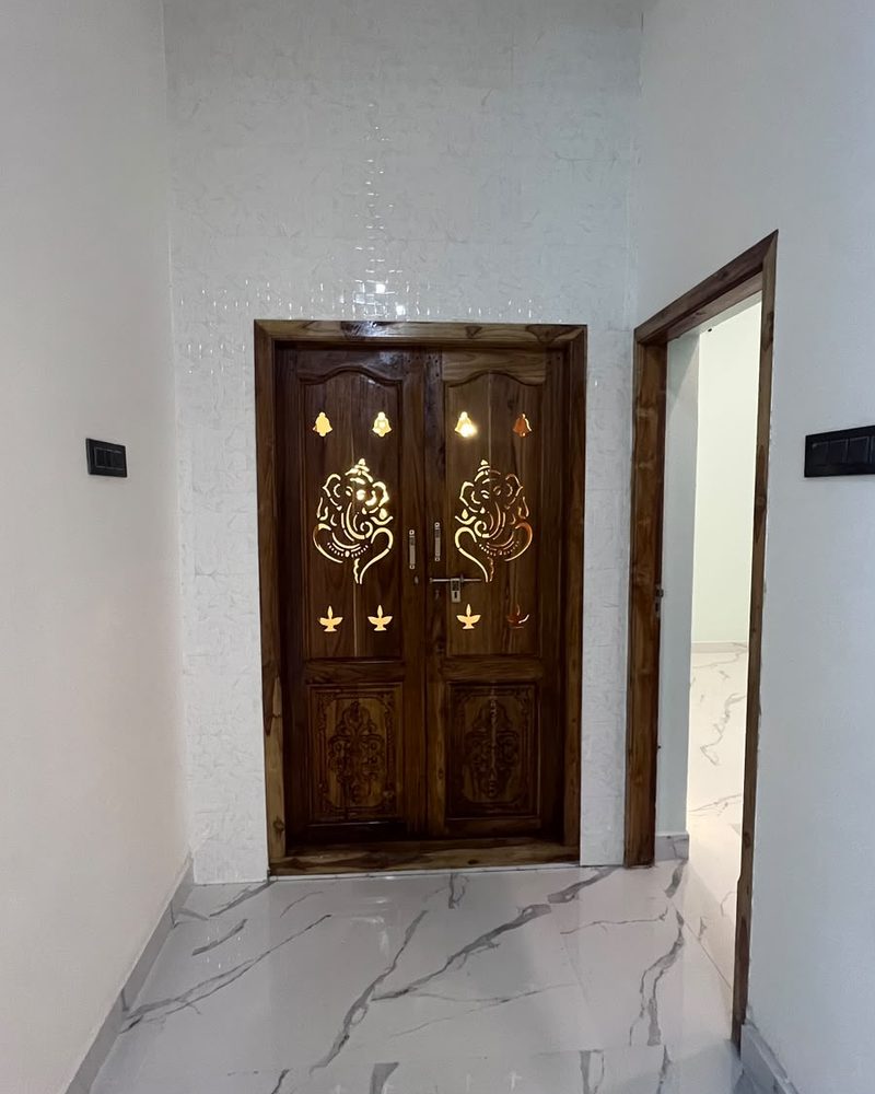 Carved wooden double door with brass motifs