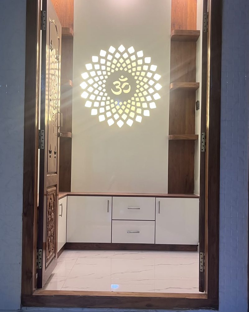 Pooja room with a backlit Om motif and built-in storage